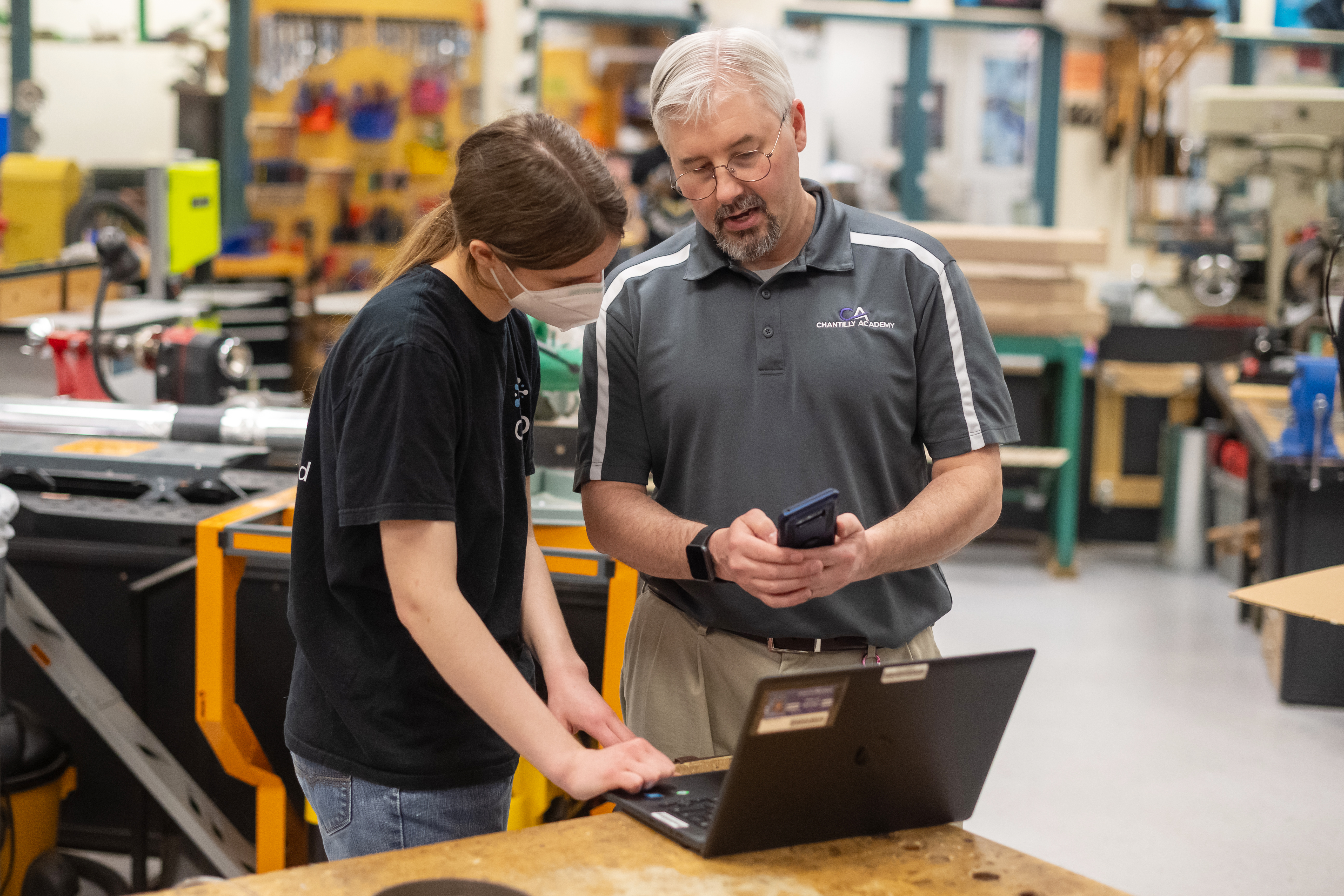 Engineering Teacher Michael Piccione working with student Tara Magill.