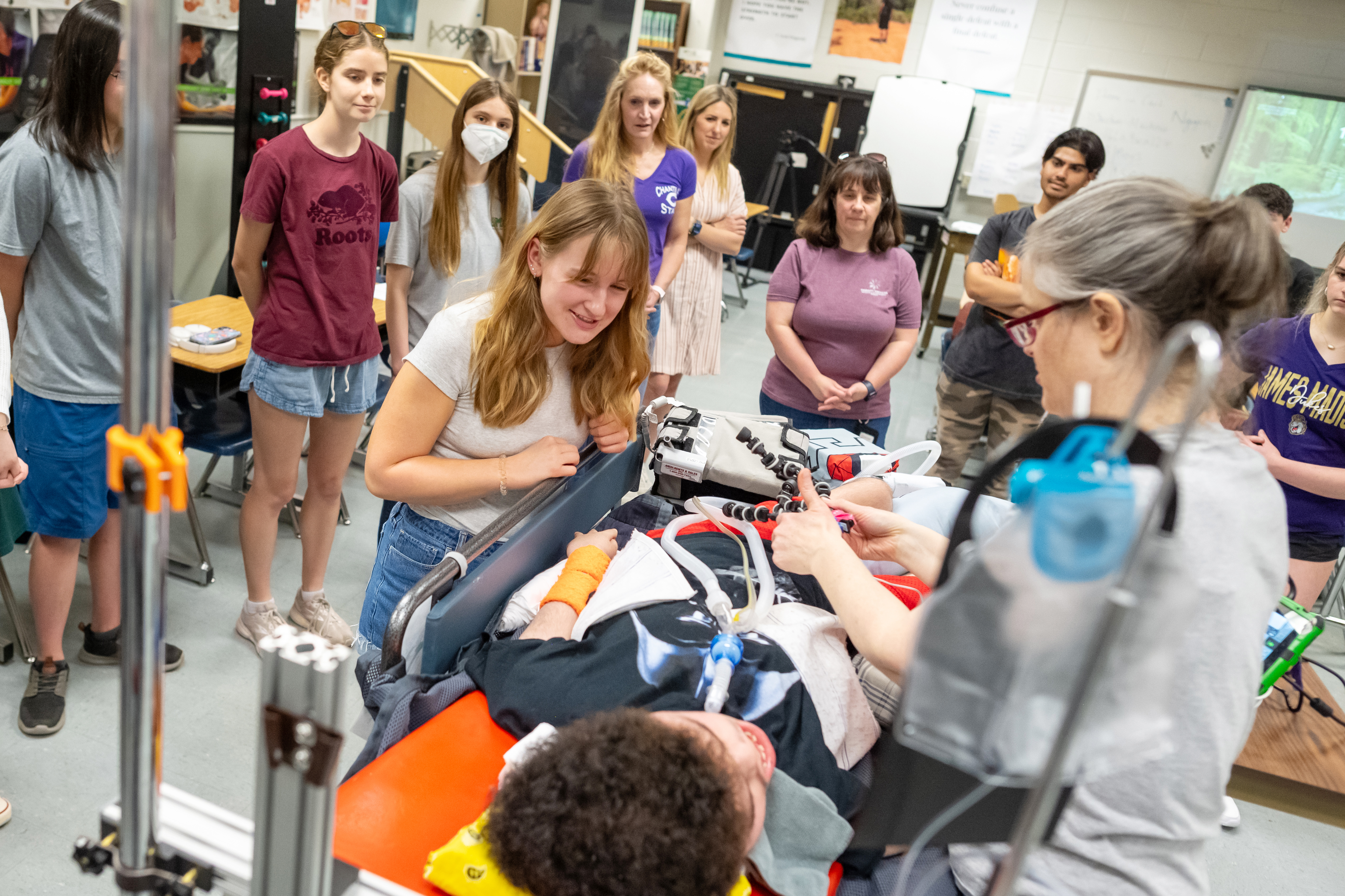 PT/OT student Kirsten Park speaks with Liam before she helps set up his talking device.