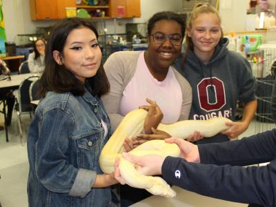 students holding snake