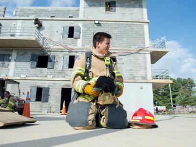 student taking rest during firefighting training